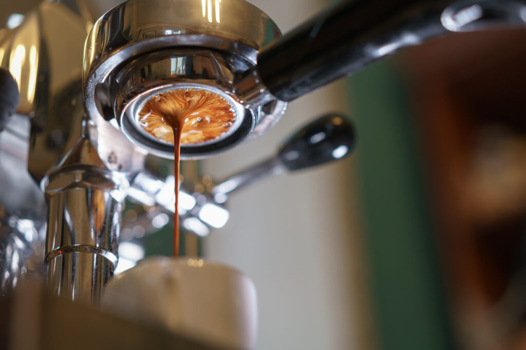 espresso pouring from bottomless portafilter, low angle shot